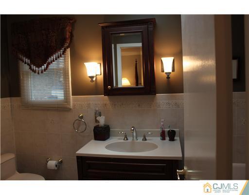 295 Marshall Road North Brunswick, NJ 08902 - Photo 11 of 19 a bathroom with a sink and a mirror
