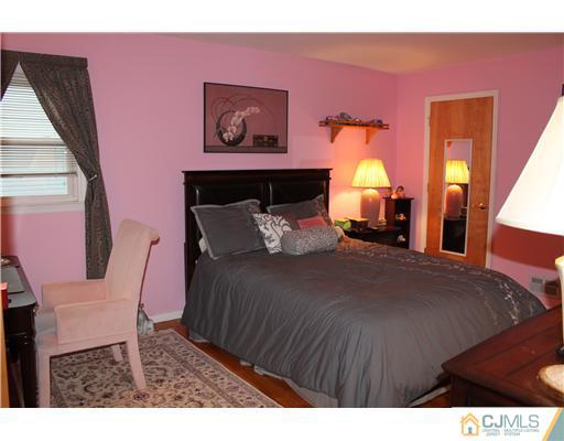 295 Marshall Road North Brunswick, NJ 08902 - Photo 14 of 19 a bedroom with a bed and wooden floor