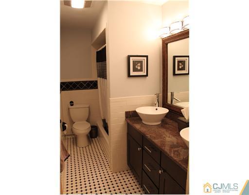 295 Marshall Road North Brunswick, NJ 08902 - Photo 16 of 19 a bathroom with a granite countertop sink mirror vanity and toilet