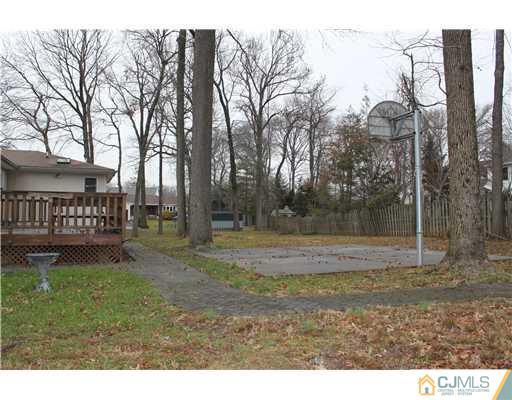 295 Marshall Road North Brunswick, NJ 08902 - Photo 18 of 19 a view of a yard with large trees and a barn