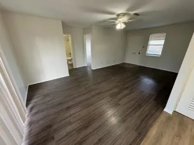 wooden floor in an empty room with a window