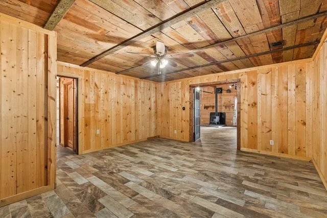 a view of a hallway with wooden walls