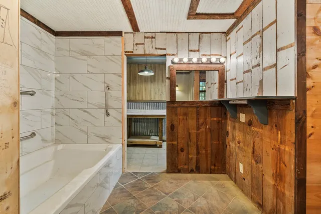 a bathroom with a bathtub and a shower