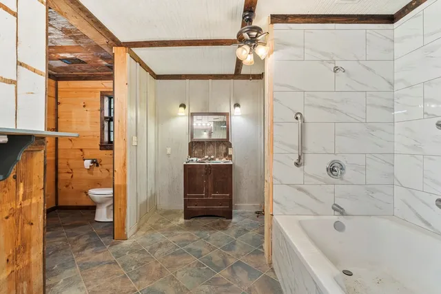 a bathroom with a bathtub and a shower