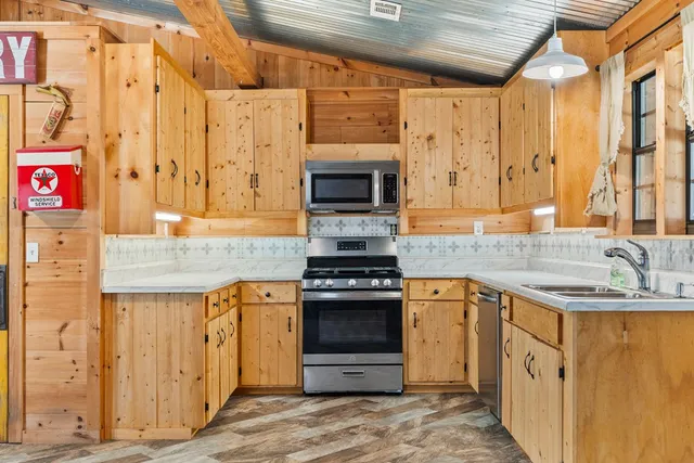 a kitchen with stainless steel appliances granite countertop a stove and a sink