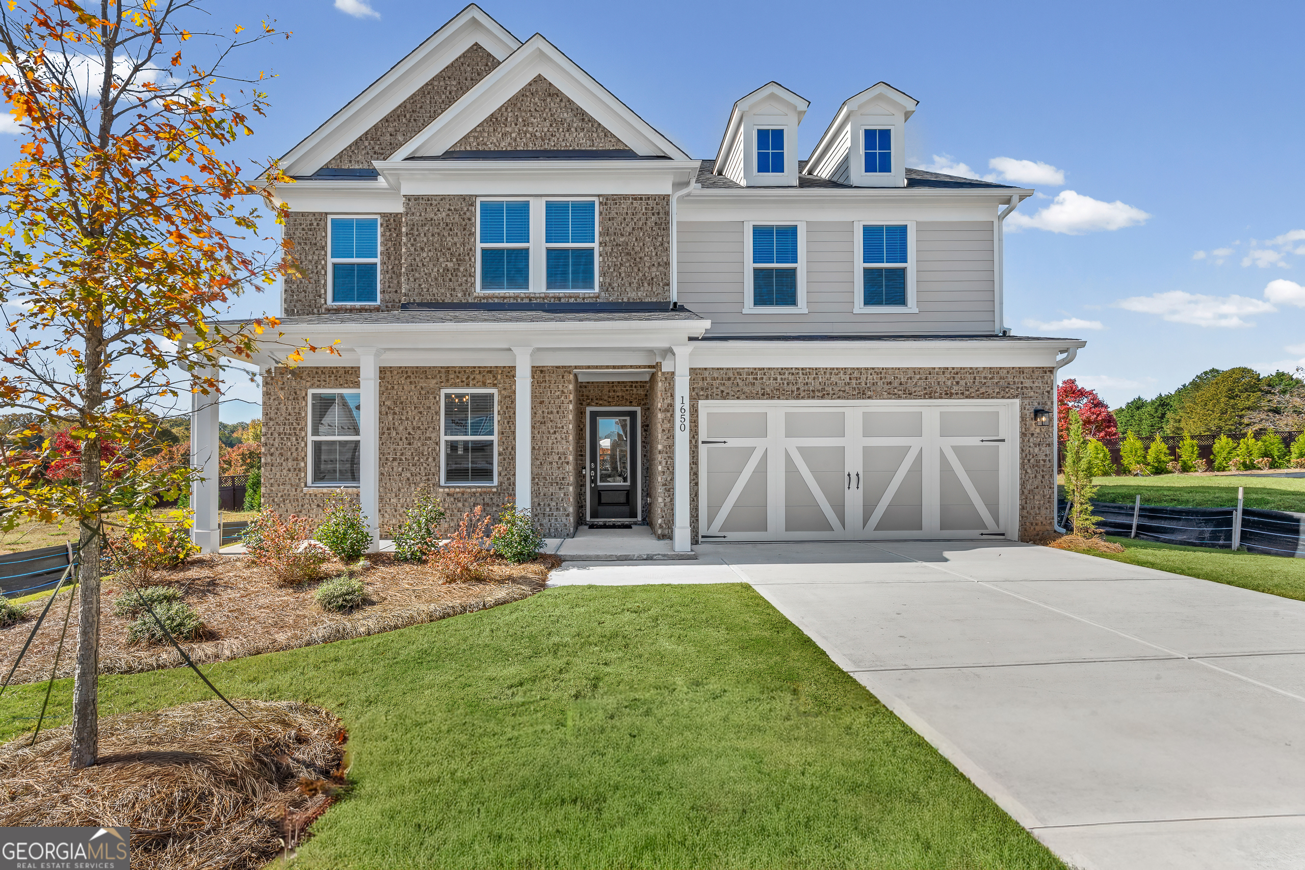 a front view of a house with garden