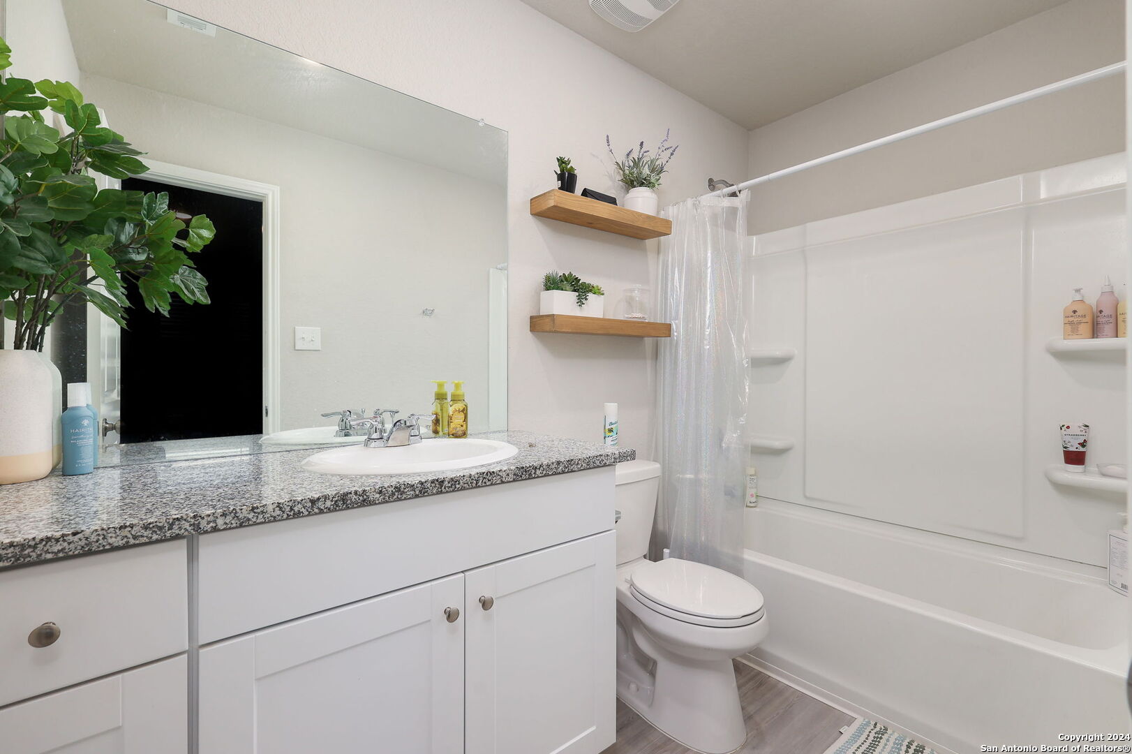 5359 Forbs Lane Bulverde, TX 78163 - Photo 11 of 21 a bathroom with a granite countertop sink a toilet and shower