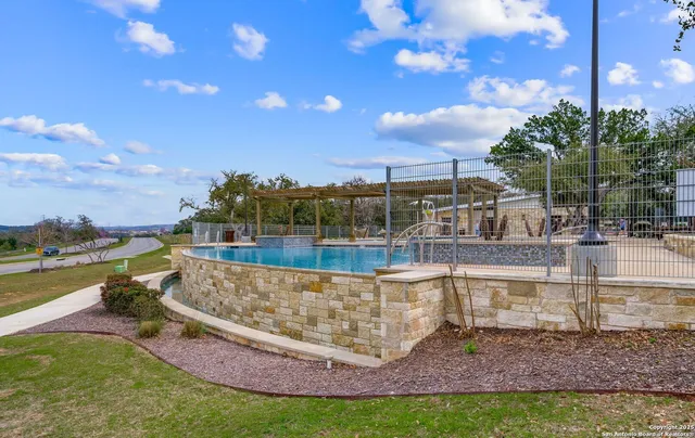 a view of a swimming pool with a lounge chair