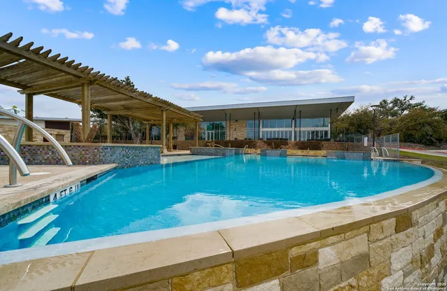 a view of a swimming pool with a patio