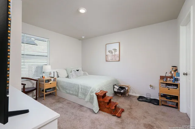 a room with a baby bed and a couch