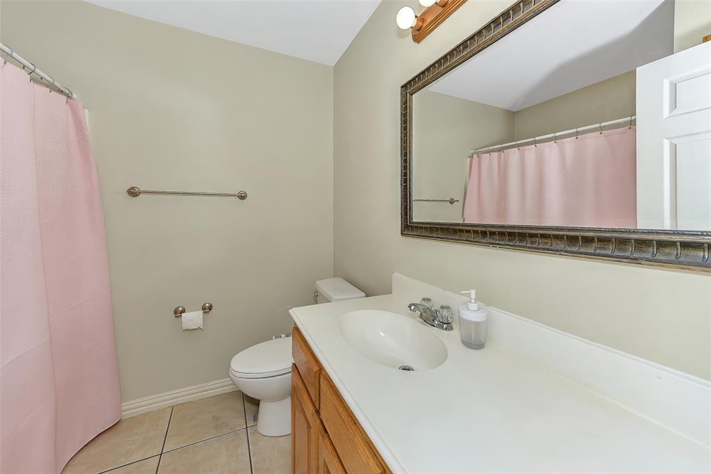 203 North Church Street Blue Ridge, TX 75424 - Photo 13 of 18 a bathroom with a sink a toilet and a mirror