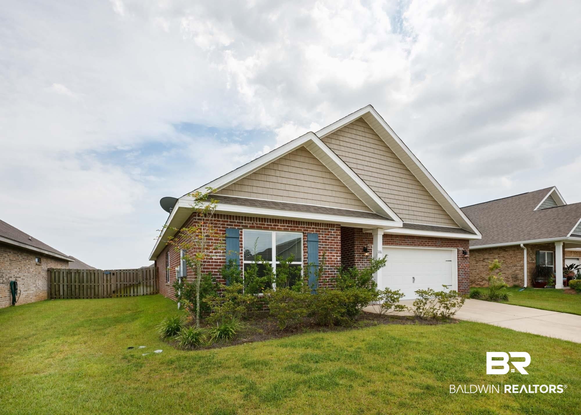 1436 Kairos Loop Foley, AL 36535 - Photo 1 of 52 View of front facade featuring driveway, brick siding, and an attached garage