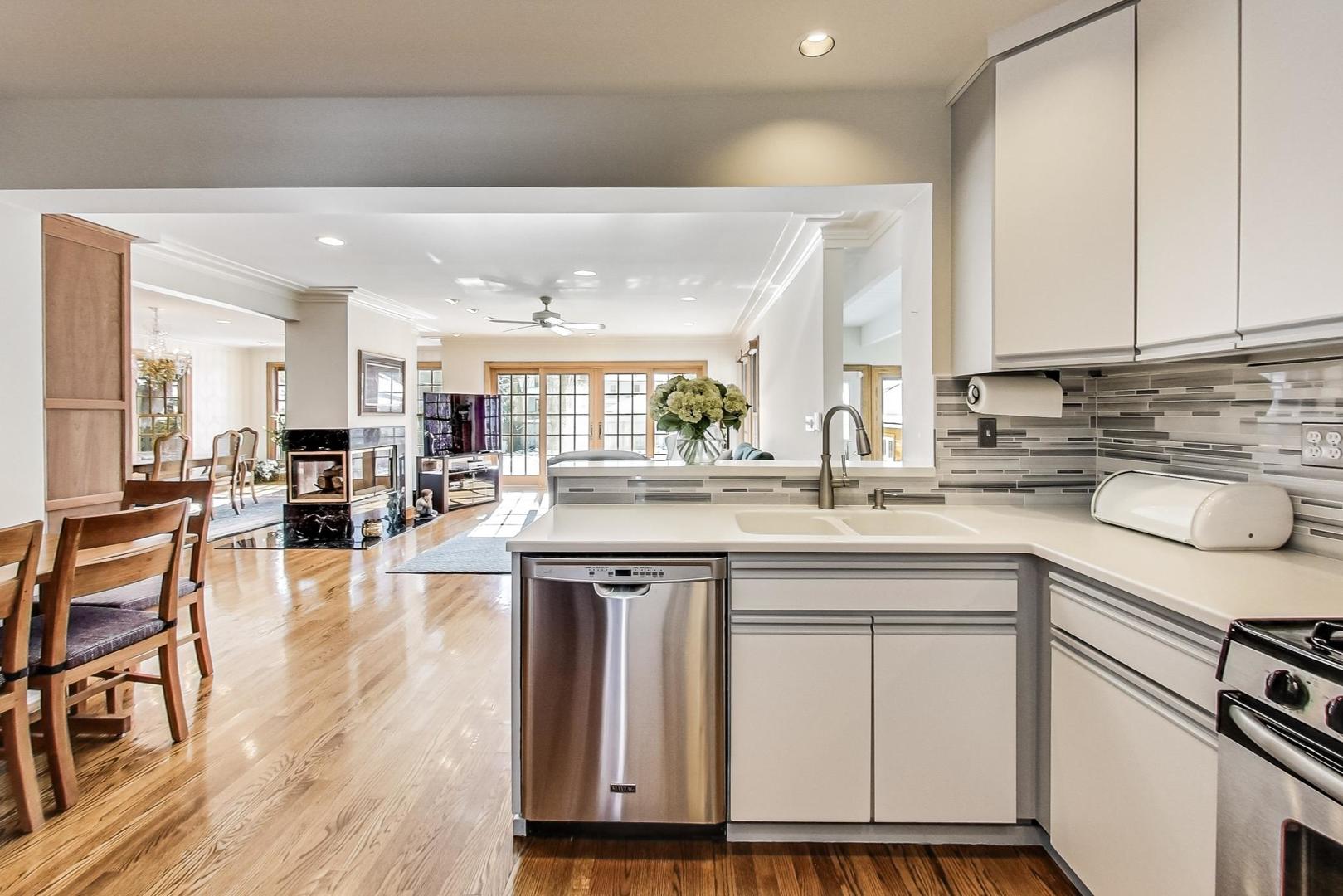 1166 Cherry Street Winnetka, IL 60093 - Photo 12 of 44 a kitchen with stainless steel appliances granite countertop a table chairs sink and cabinets