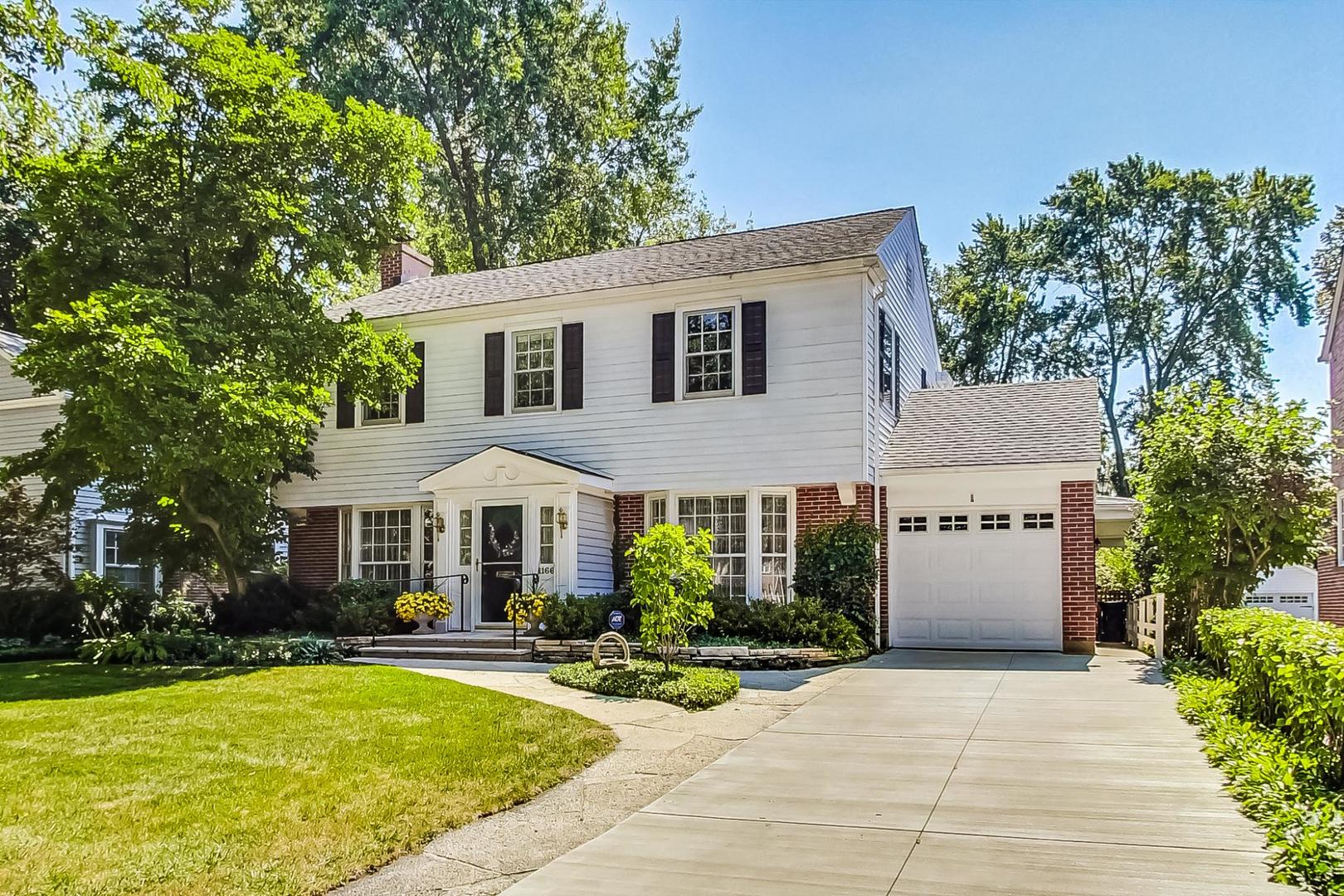 1166 Cherry Street Winnetka, IL 60093 - Photo 2 of 44 a front view of a house with yard and garage