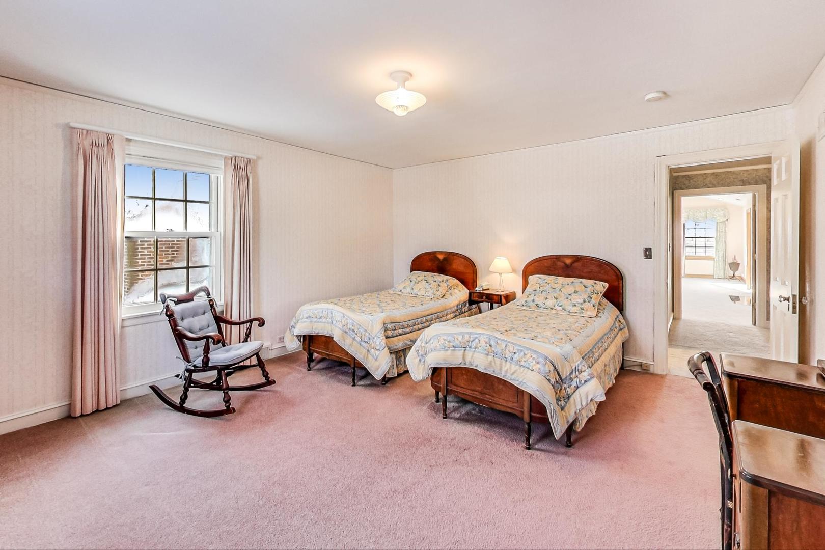 1166 Cherry Street Winnetka, IL 60093 - Photo 29 of 44 a spacious bedroom with two beds and a chandelier