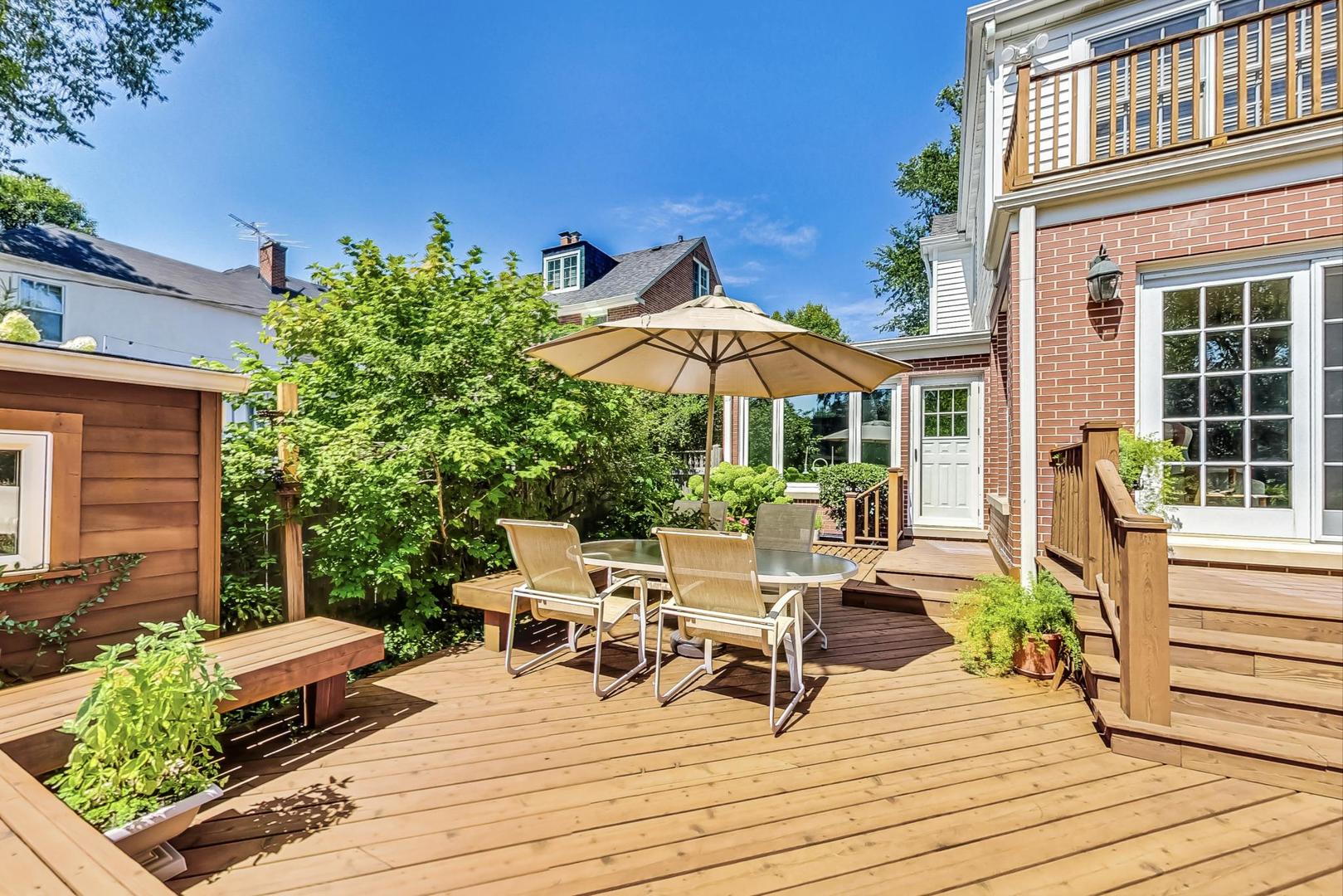 1166 Cherry Street Winnetka, IL 60093 - Photo 35 of 44 a view of a house with backyard sitting area and garden