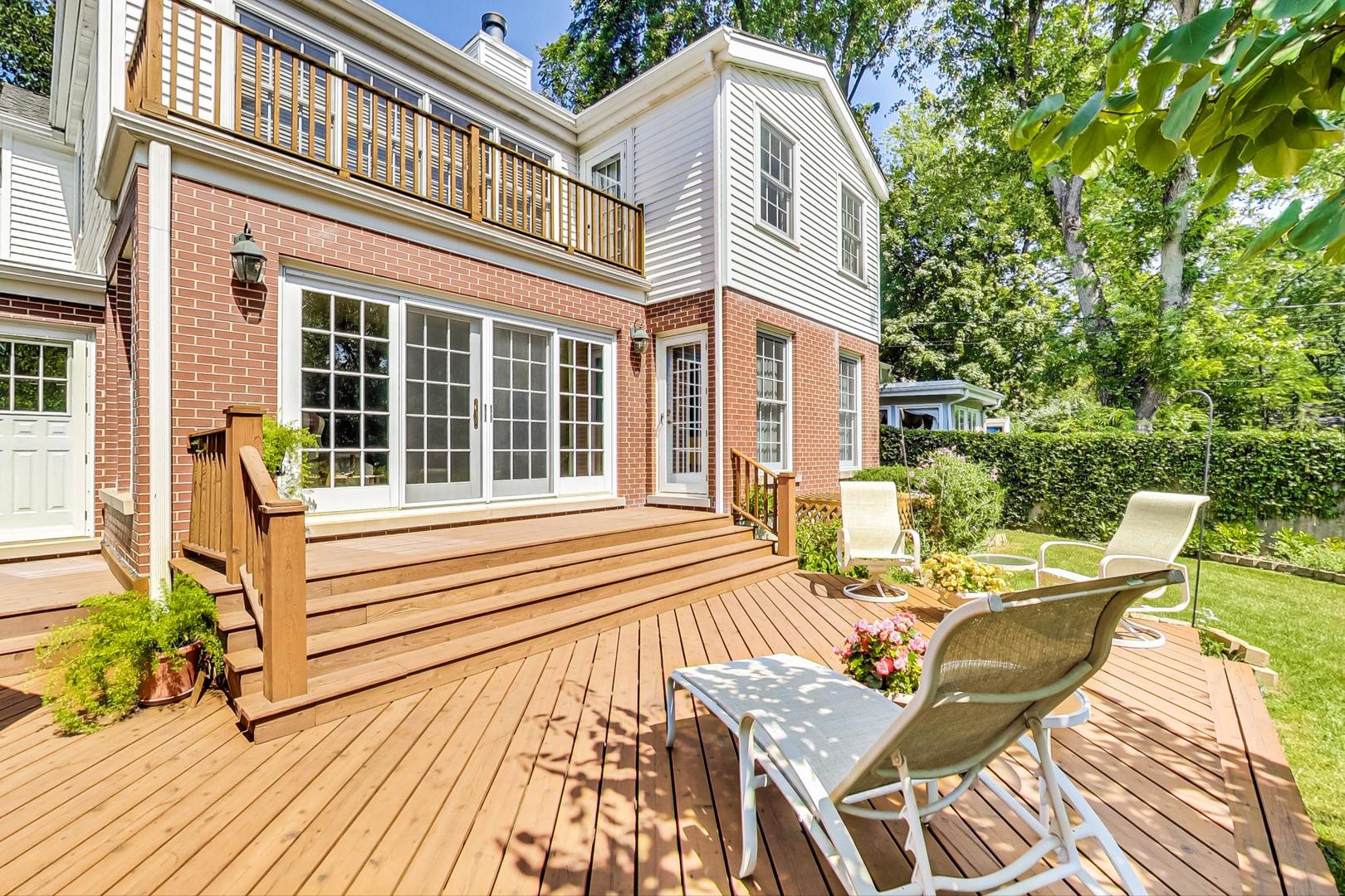 1166 Cherry Street Winnetka, IL 60093 - Photo 37 of 44 a view of a patio with a table and chairs and wooden floor