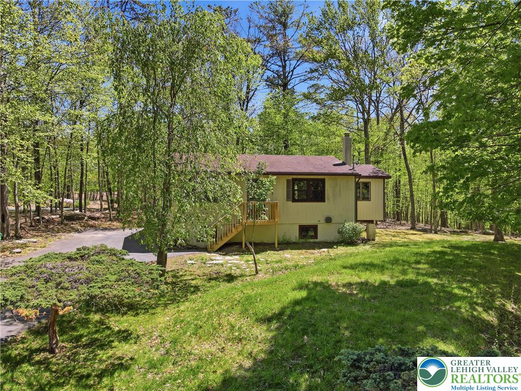 505 Chipmunk Road Bushkill, PA 18324 - Photo 36 of 46 a view of an house with backyard space and sitting area