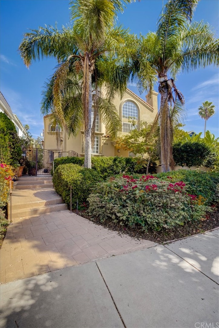 a front view of a house with a garden