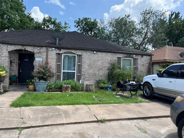 a front view of a house with a yard and a garage
