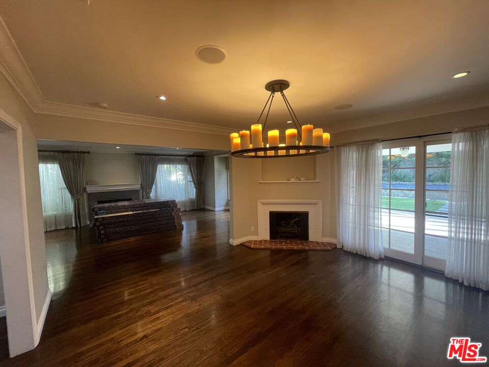 9500 Cresta Drive Los Angeles, CA 90035 - Photo 4 of 13 a view of a room with wooden floor fireplace and windows