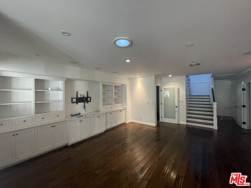 9500 Cresta Drive Los Angeles, CA 90035 - Photo 5 of 13 a view of a kitchen with wooden floor and white cabinets
