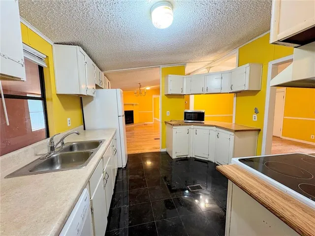 a kitchen that has a sink and a stove