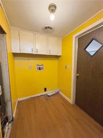 a view of a room with wooden floor