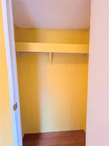 a view of closet with wooden floor