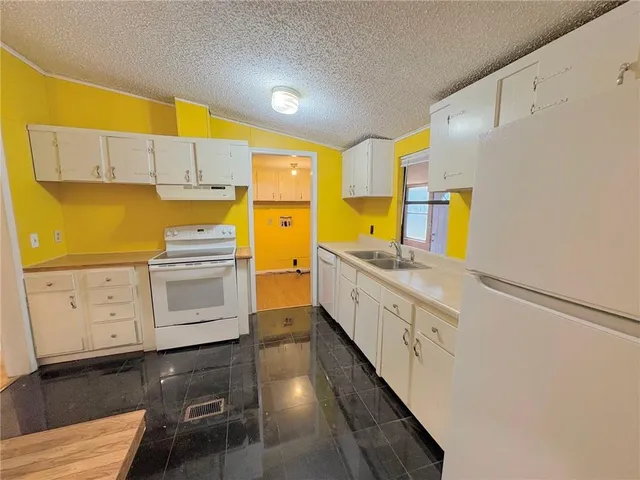 a kitchen with cabinets a sink and appliances