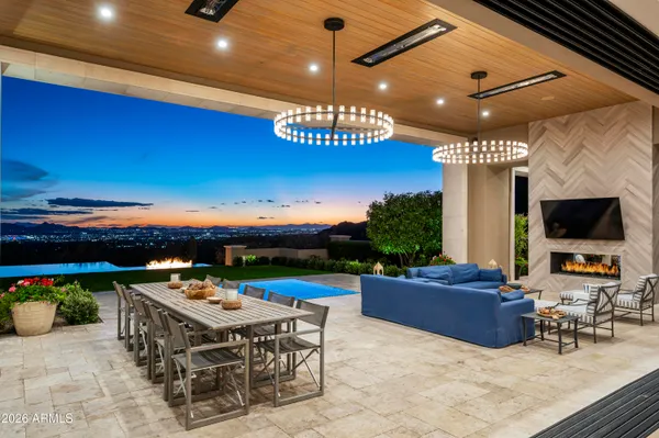 a living room with stainless steel appliances kitchen island granite countertop furniture and a flat screen tv