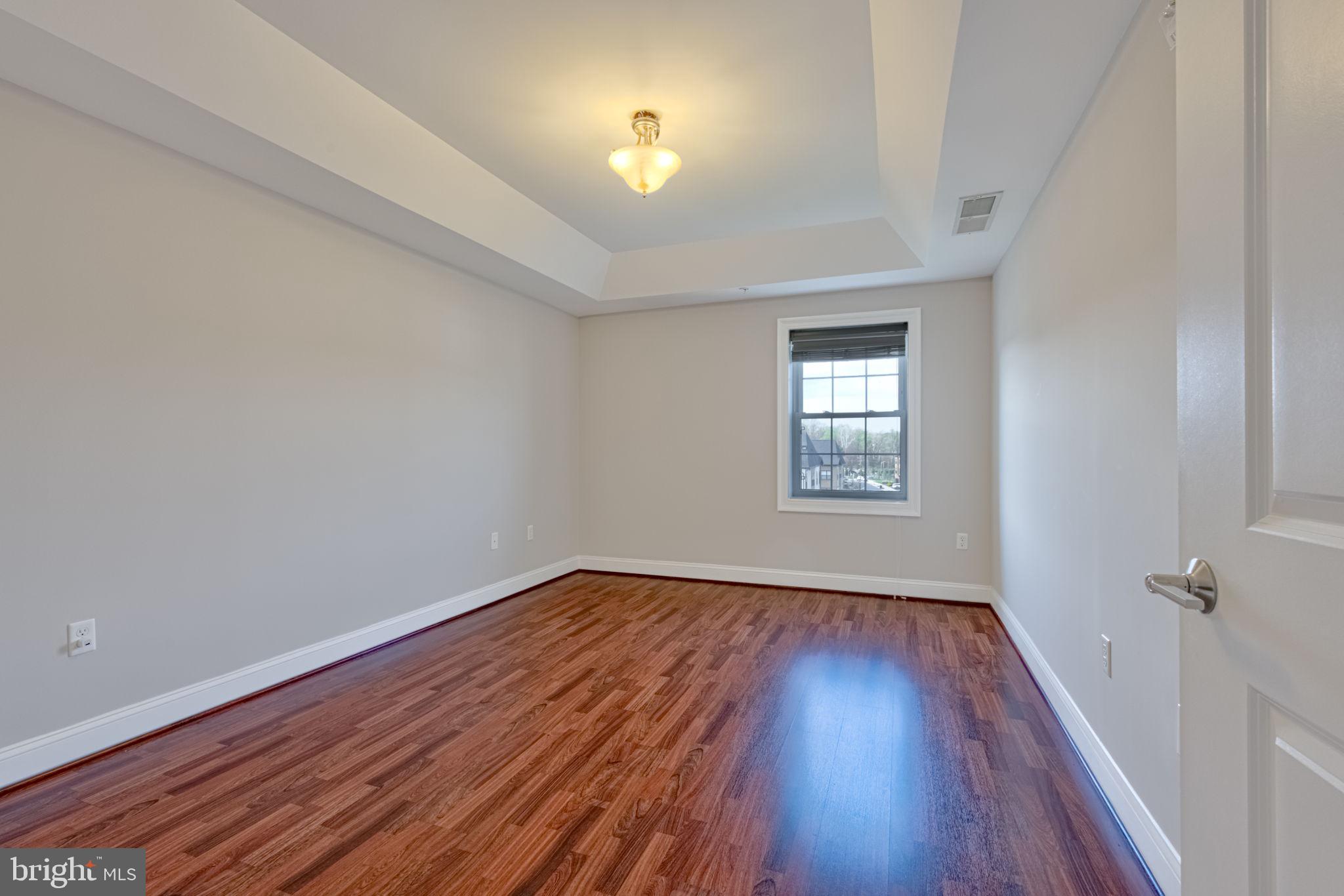 6301 Edsall Road, Unit 418 Alexandria, VA 22312 - Photo 17 of 44 wooden floor in an empty room with a window