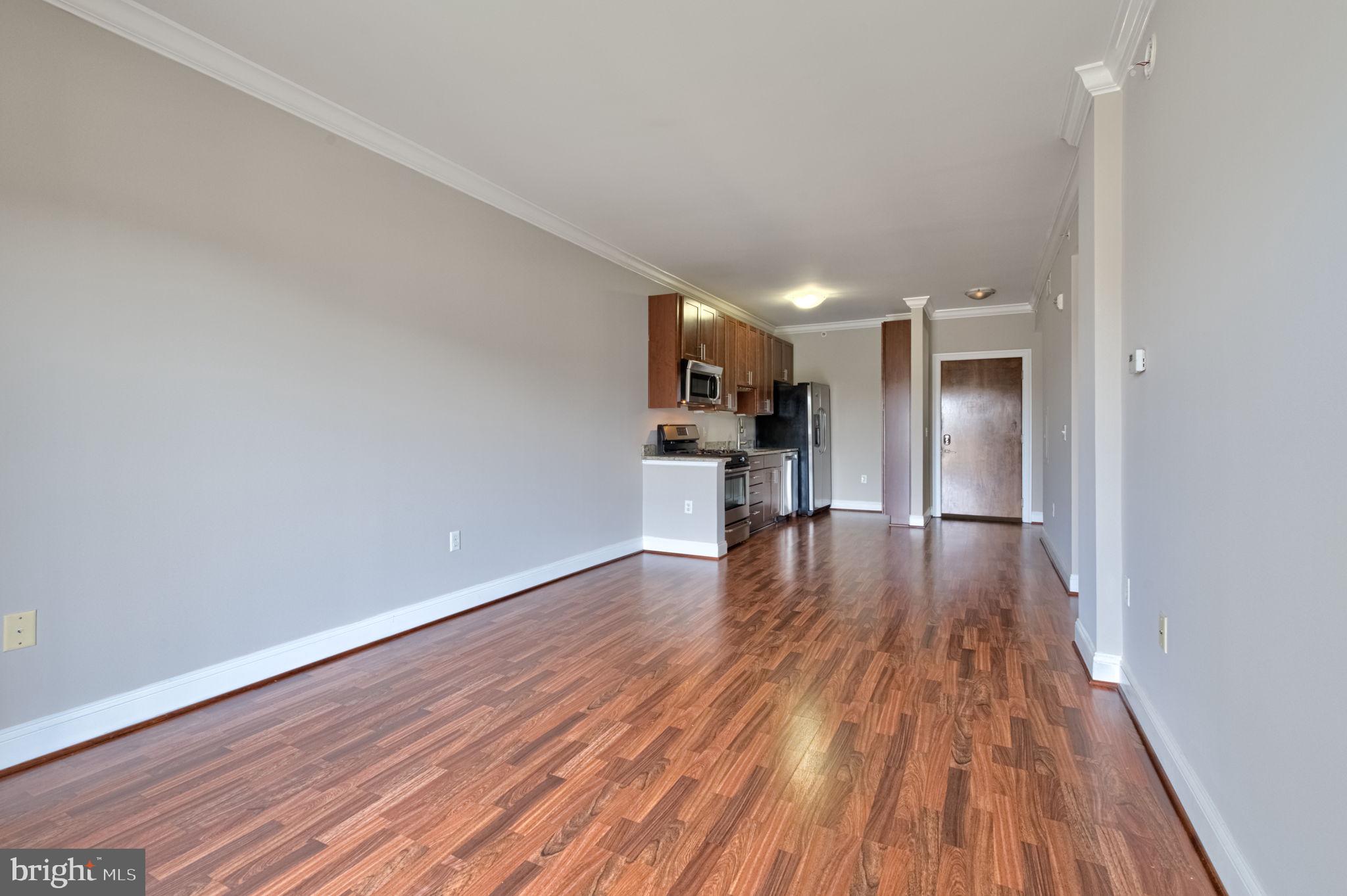 6301 Edsall Road, Unit 418 Alexandria, VA 22312 - Photo 19 of 44 a view of a big room with wooden floor and a window