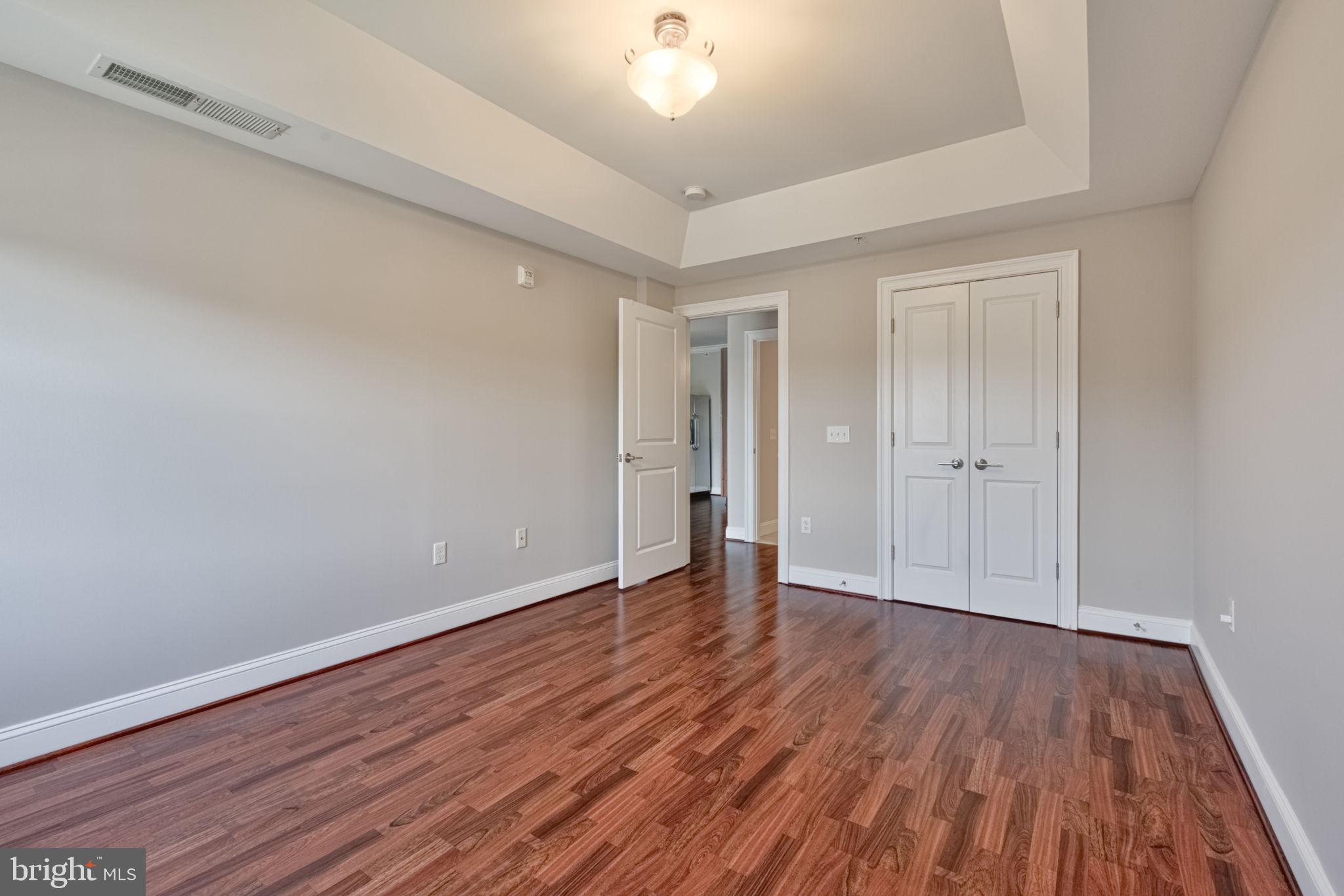 6301 Edsall Road, Unit 418 Alexandria, VA 22312 - Photo 23 of 44 a view of an empty room with wooden floor
