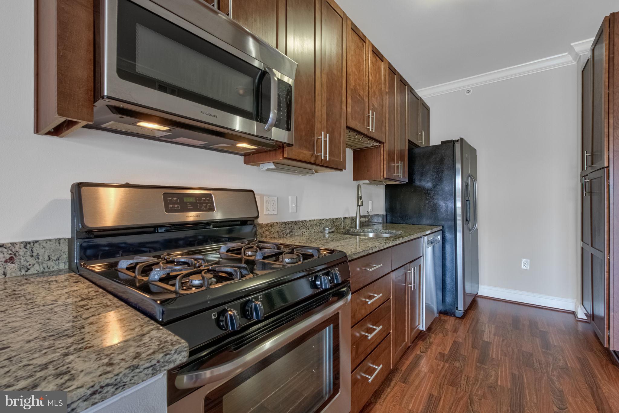 6301 Edsall Road, Unit 418 Alexandria, VA 22312 - Photo 28 of 44 a kitchen with stainless steel appliances granite countertop a stove and a microwave