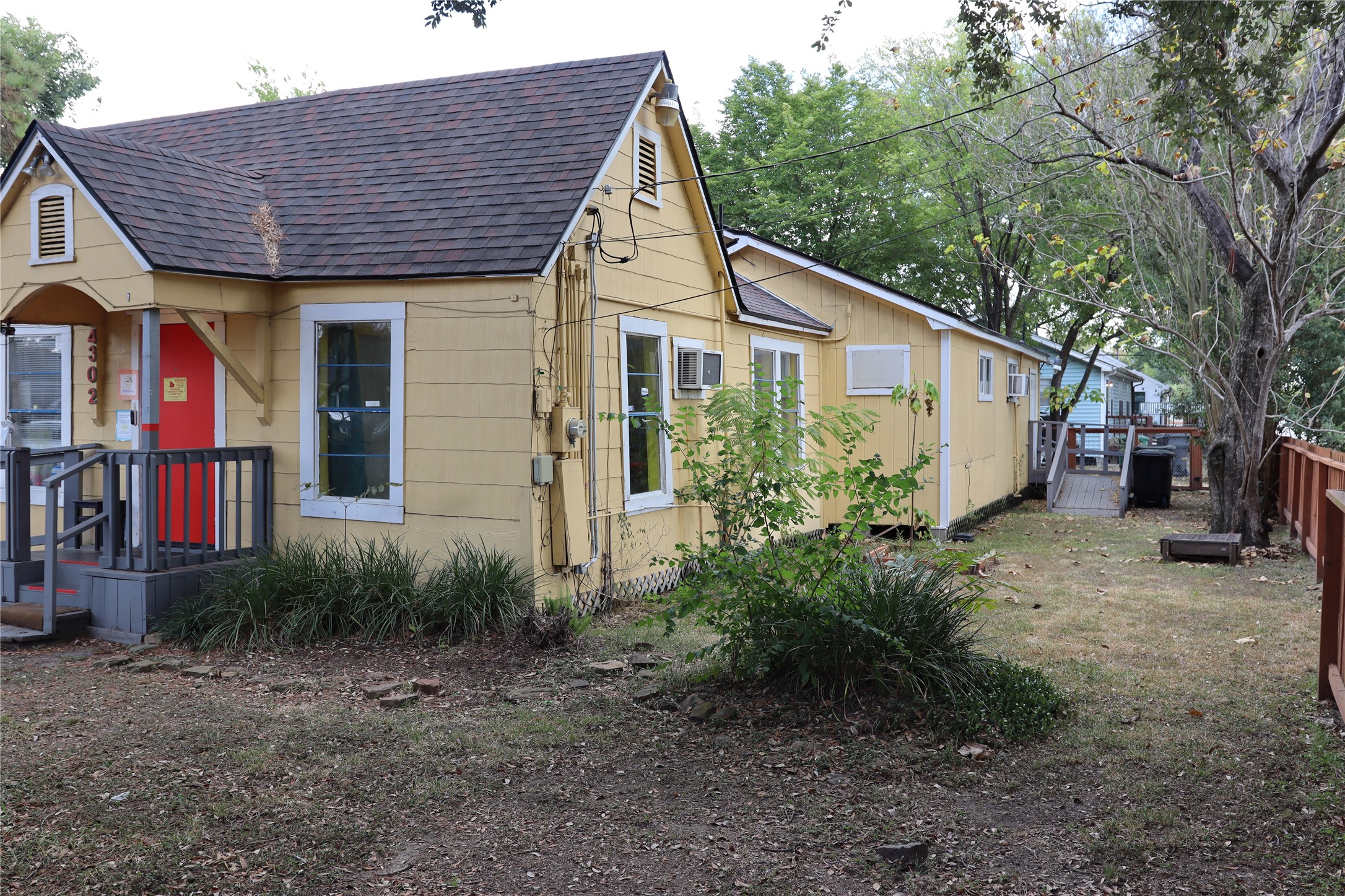 4302 Delhi Street Houston, TX 77022 - Photo 21 of 23 a view of a house that has wooden fence and a large tree