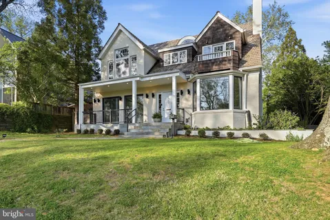 a view of a house with a yard balcony and sitting area