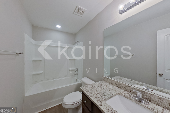 101 St Phillip Way Springfield, GA 31329 - Photo 16 of 25 a bathroom with a granite countertop sink a toilet and shower