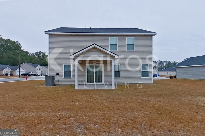 101 St Phillip Way Springfield, GA 31329 - Photo 22 of 25 a front view of a house with a yard and garage