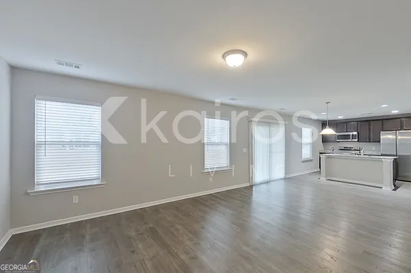 a view of a kitchen with a sink cabinets and wooden floor
