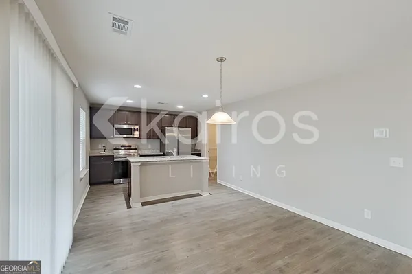a kitchen with a refrigerator and white cabinets