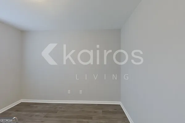 a view of a room with wooden floor