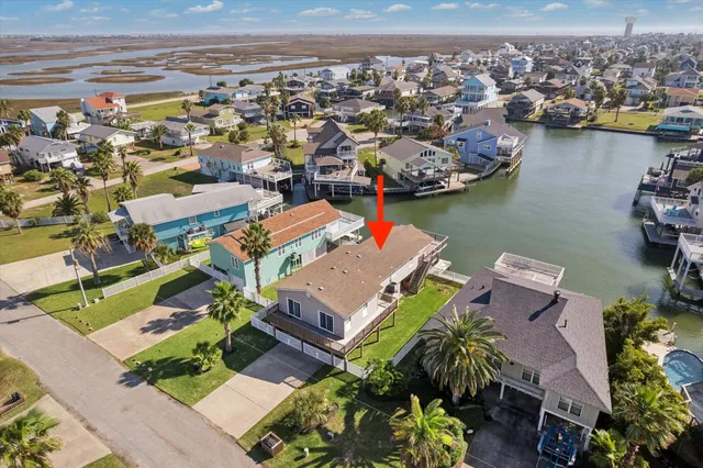 an aerial view of a houses with a lake view
