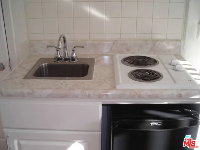 a kitchen with a sink and a stove