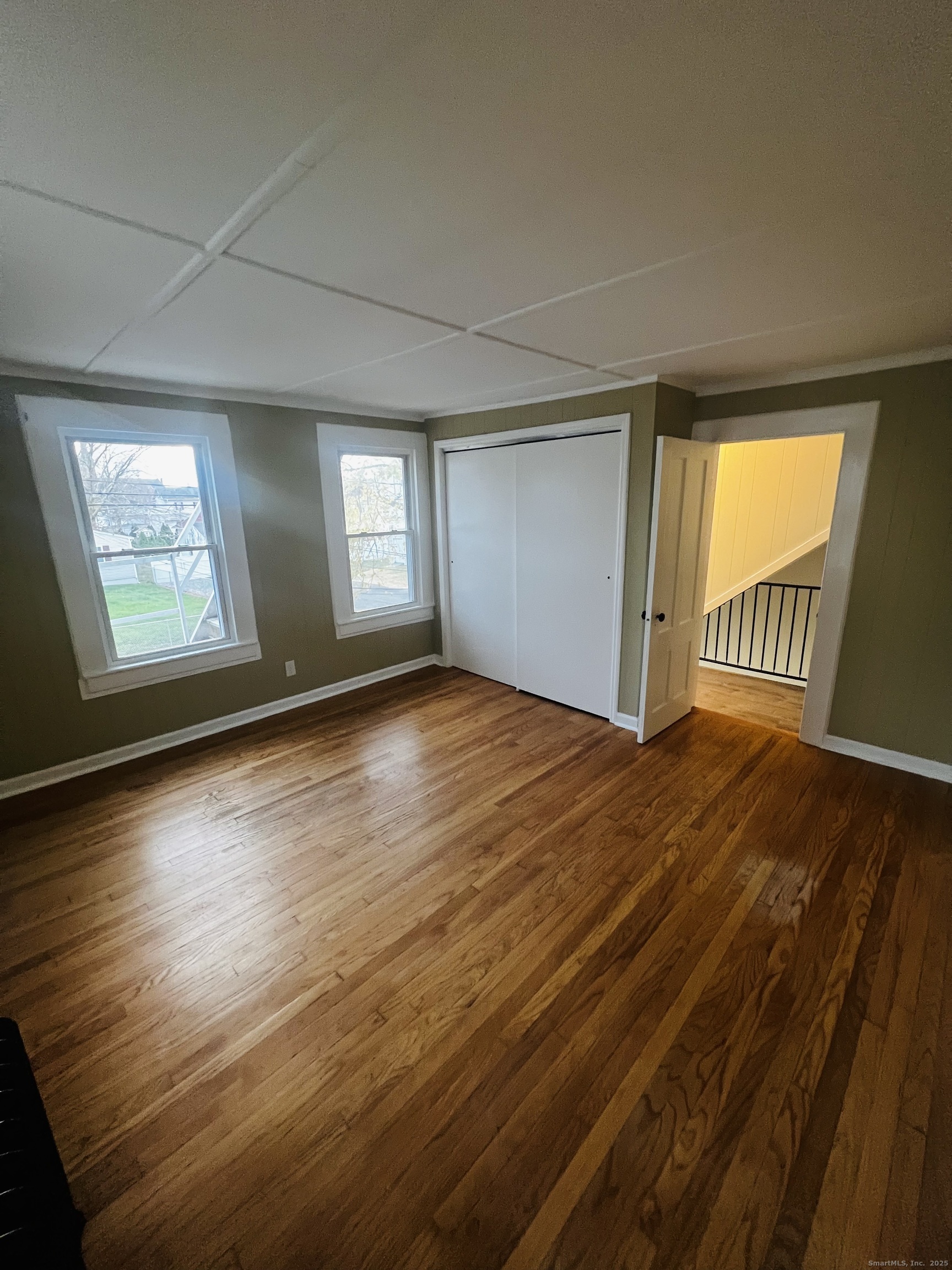 20 Lee Avenue, Unit 2 Wallingford, CT 06492 - Photo 11 of 21 an empty room with wooden floor and windows