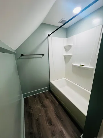 a bathroom with a sink mirror vanity and toilet