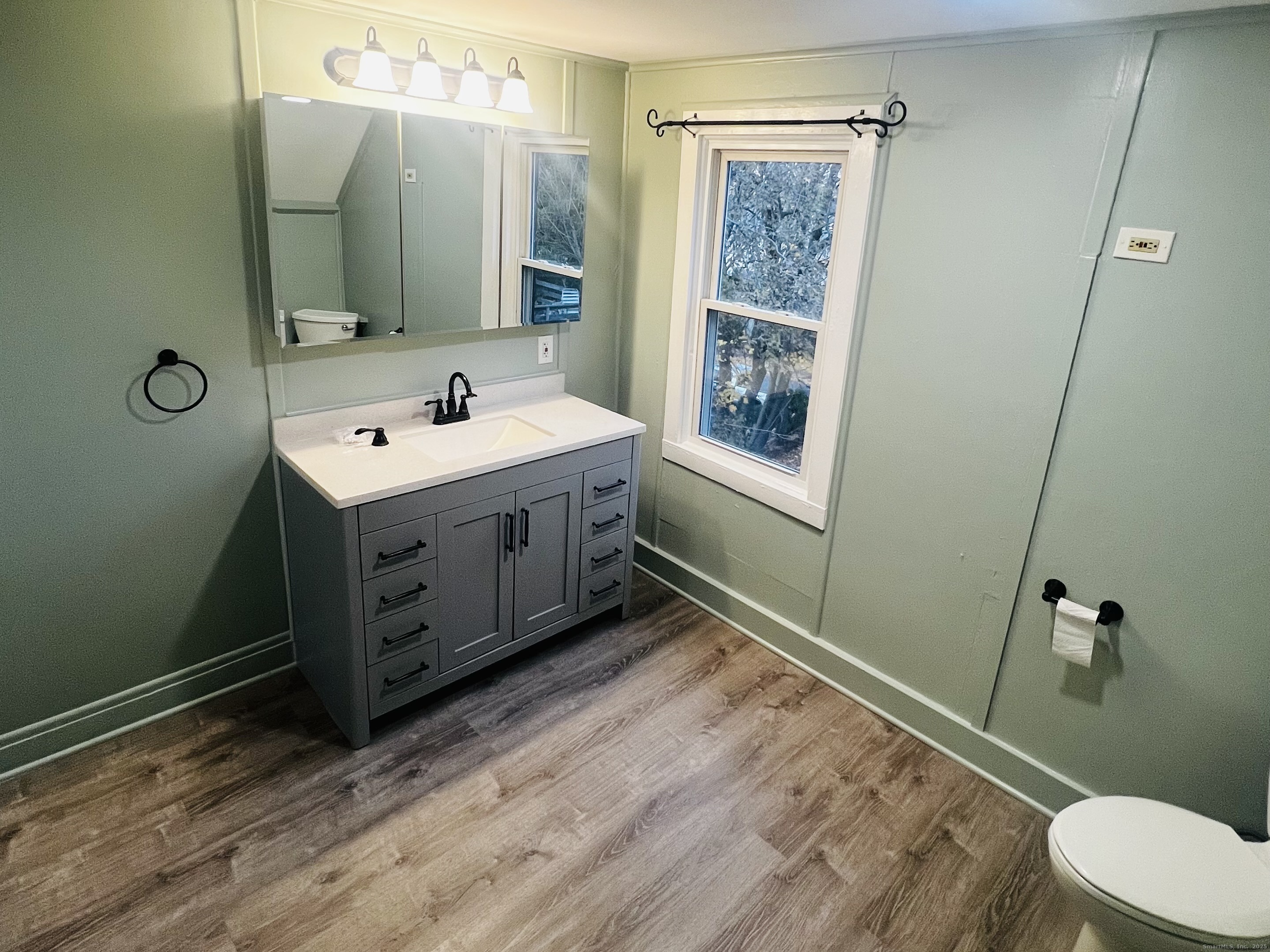 20 Lee Avenue, Unit 2 Wallingford, CT 06492 - Photo 21 of 21 a bathroom with a sink mirror vanity and toilet