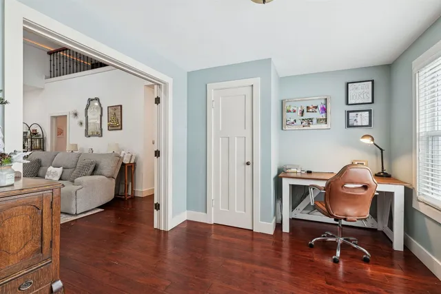 a view of a livingroom with furniture and a workspace