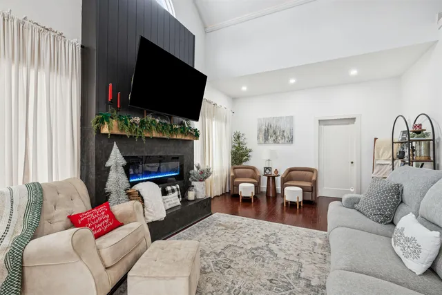 a living room with furniture fireplace and window