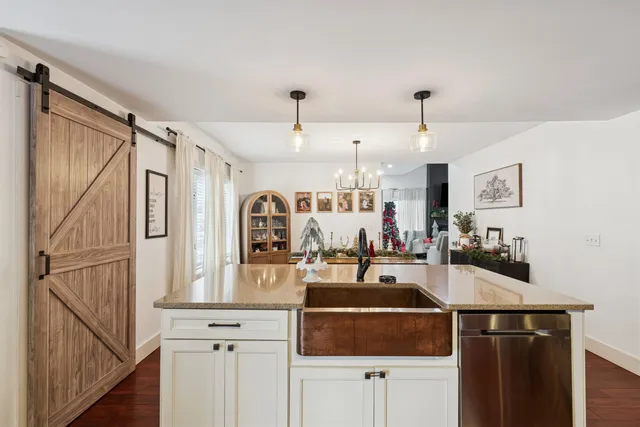 a kitchen with kitchen island a counter top space a sink and cabinets